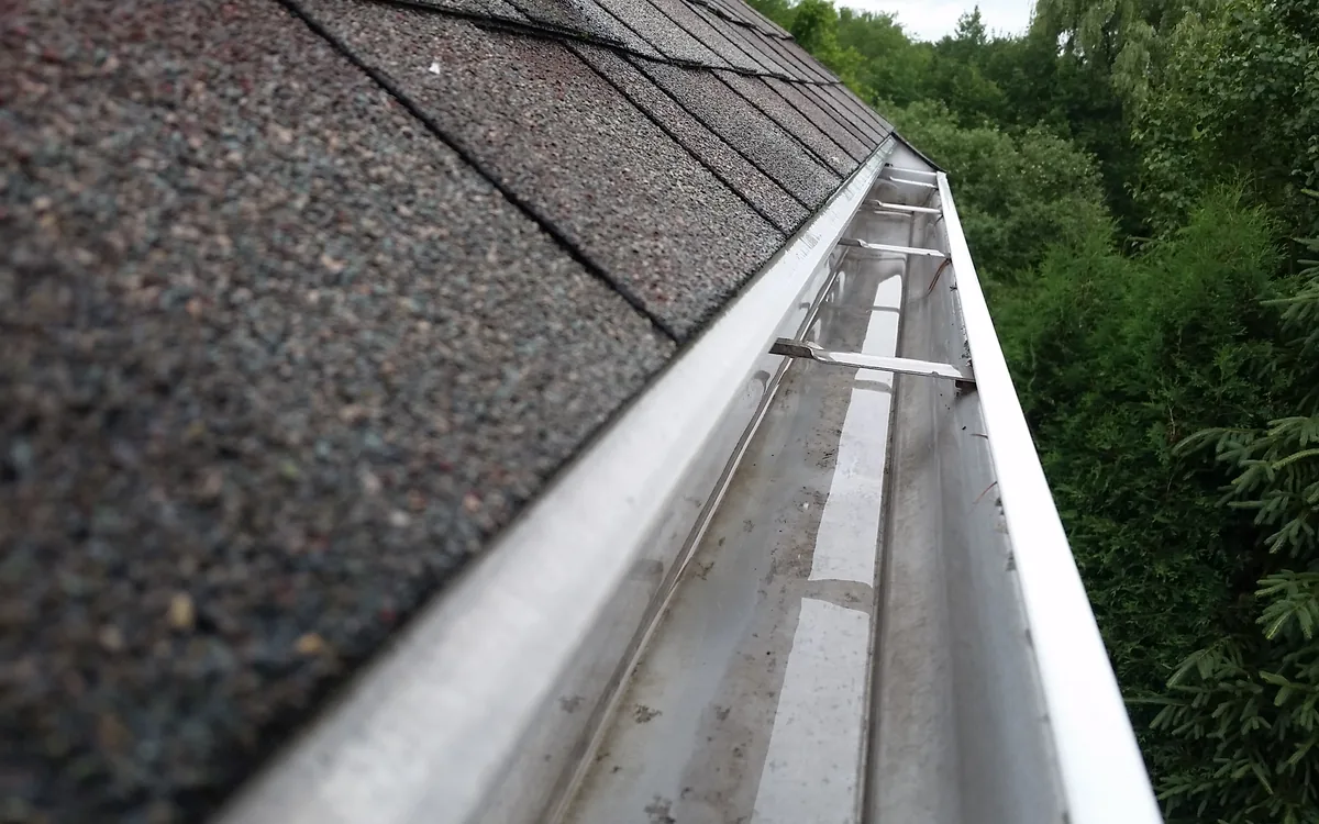 Clean gutters along a Charlotte home's roofline