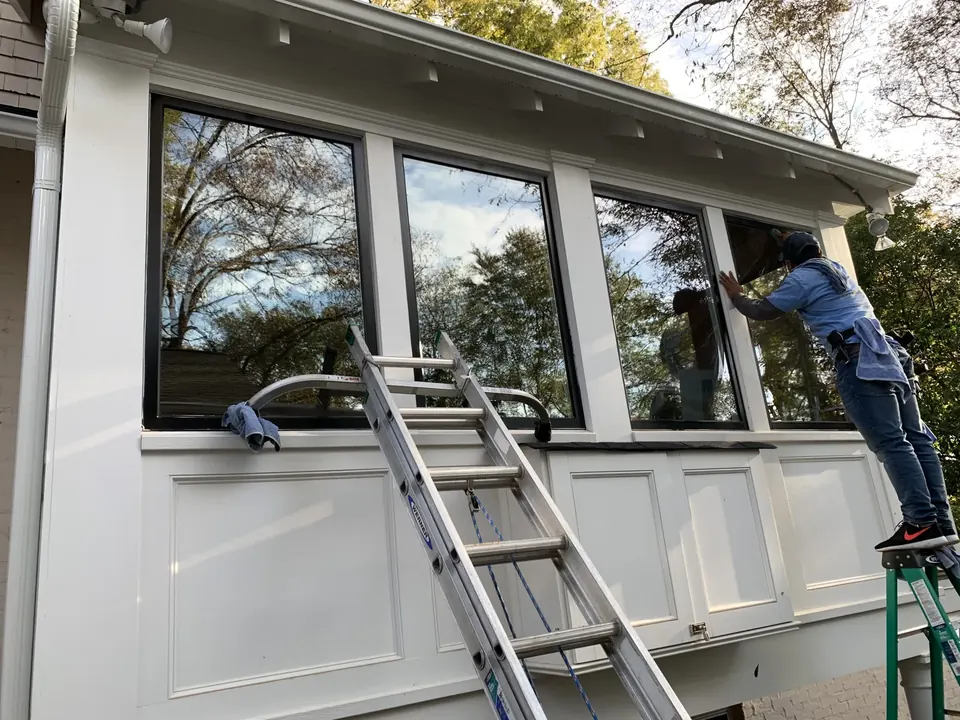 Hand-detailing residential window glass on a home in Charlotte, NC