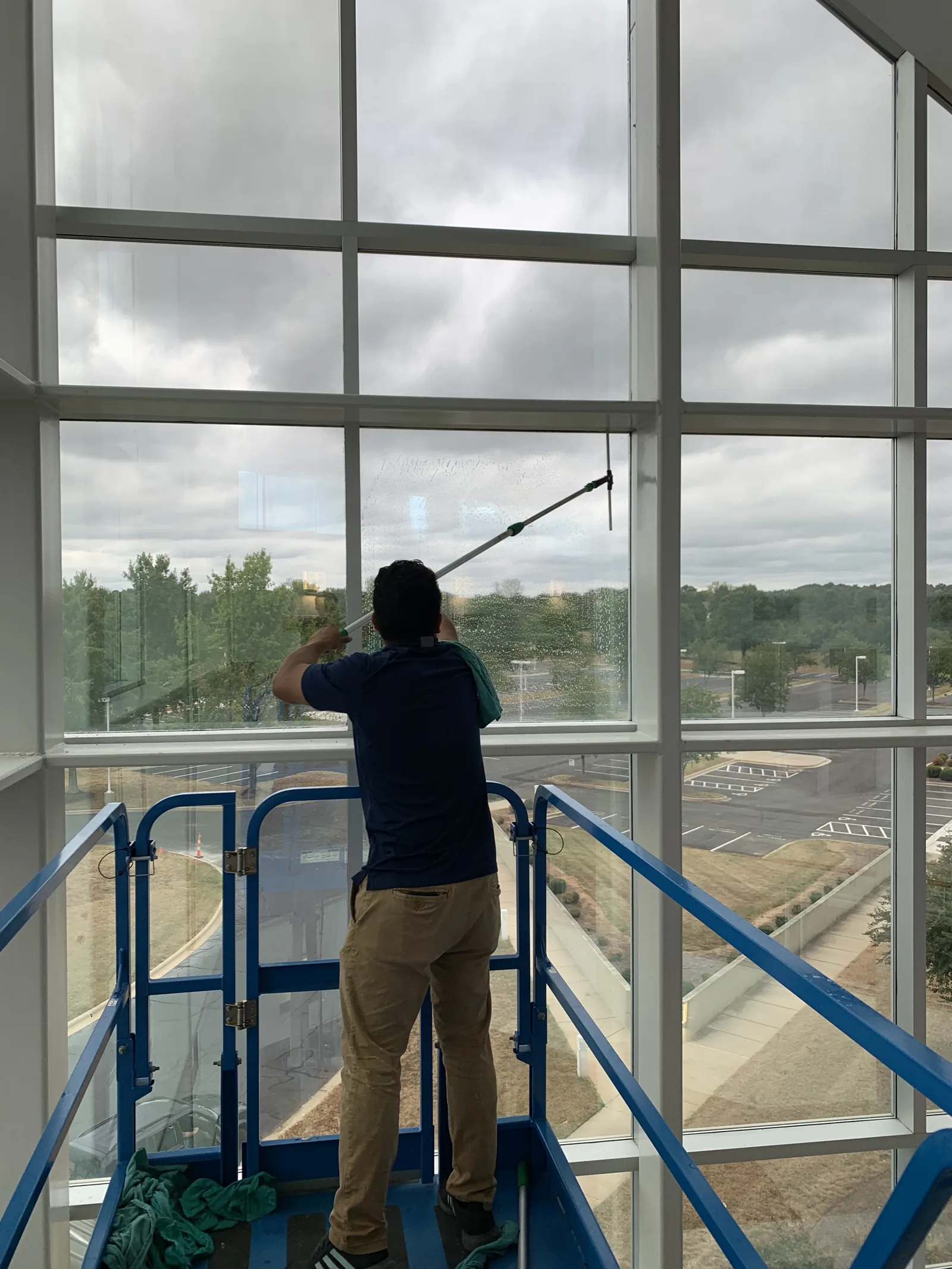 Cleaning interior glass from a lift on a tall commercial building