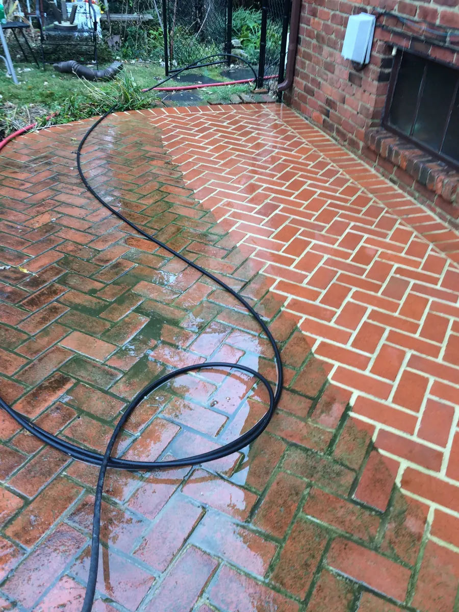 AAA technician soft washing a home exterior in Charlotte