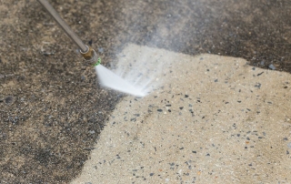 Power washer removing dirt.