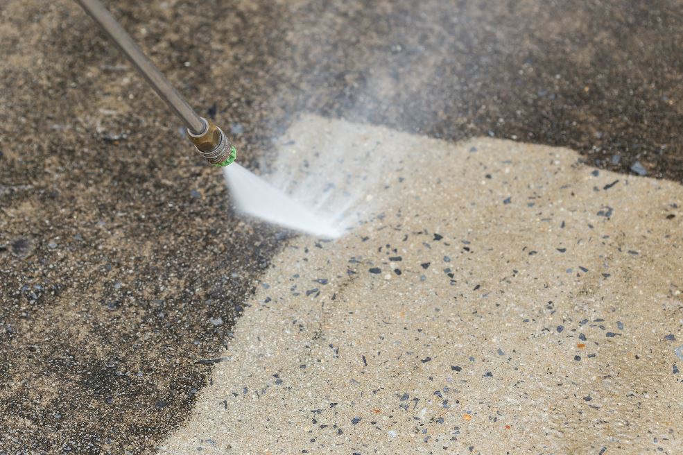 Power washer removing dirt.