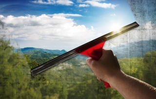 A dirty window being cleaned for spring.