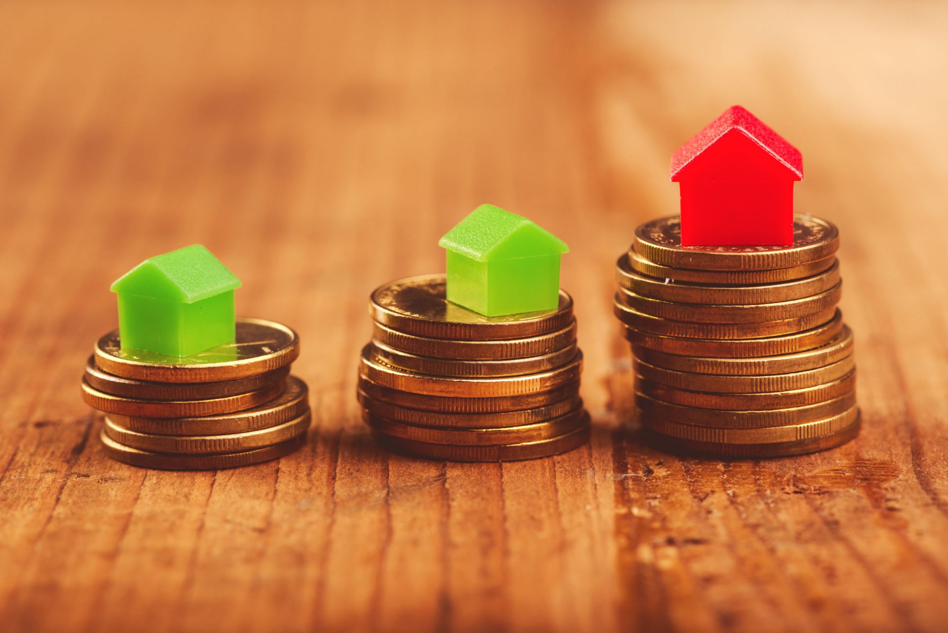 plastic houses on stacked coins